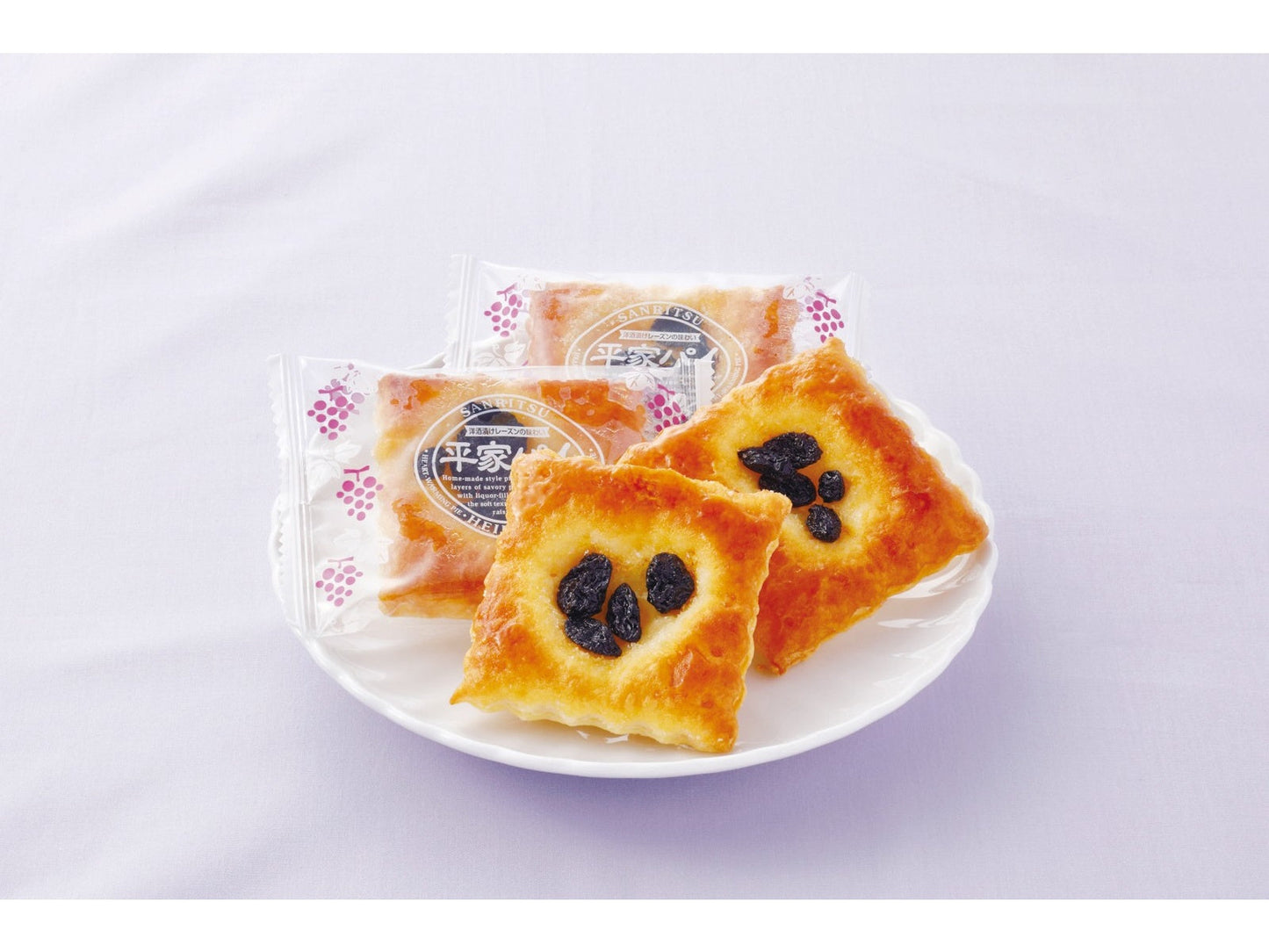 SANRITSU Heike Pie Value Pack with layered pastry topped with alcohol-soaked raisins on a plate. Contains wheat, egg, dairy, soybean.