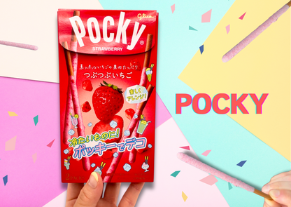 Strawberry-flavored Pocky package with colorful confetti background and hand holding a Pocky stick.