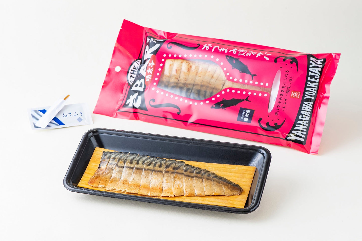 THE SABAR Smoked Mackerel with packaging, tray, toothpick, and hand towel, featuring Norwegian mackerel and Itoshima Mataichi salt.