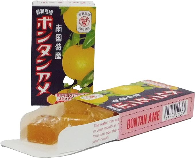 Bontan Ame soft fruit candy packaging with opened candy showing sticky texture, featuring refreshing bontan flavor. Contains allergens: soybean, orange.