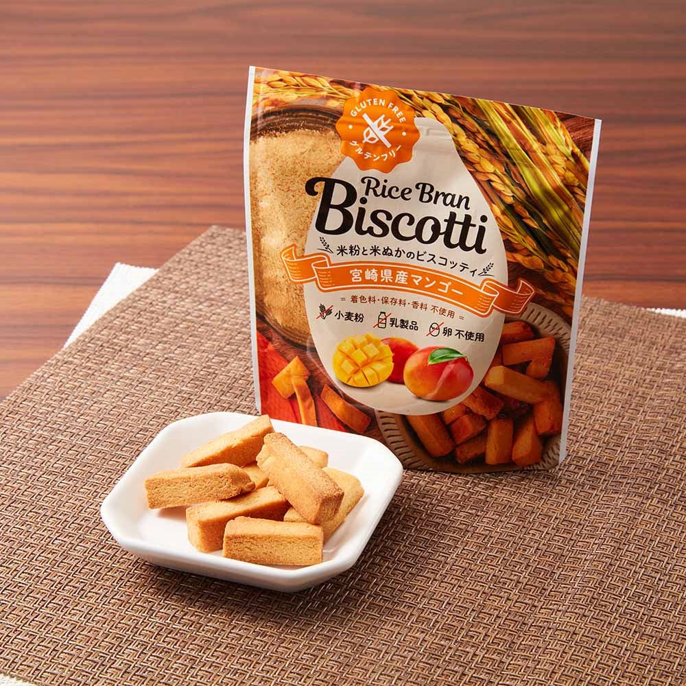 Takachiho Muratabi Gluten-free Rice Bran Biscotti with rice flour and almonds, displayed on a woven mat next to a product package.
