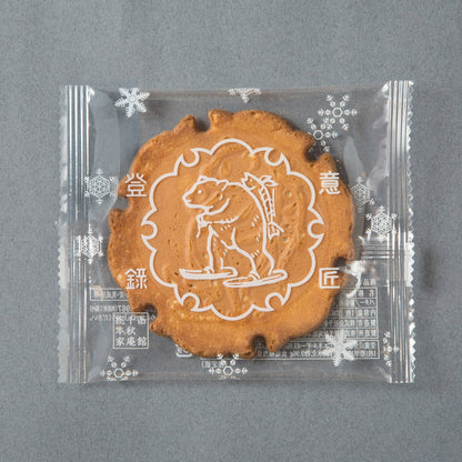 Ganso Yamaoyaji Japanese butter milk cracker in clear packaging, featuring a traditional bear design, made with unique milk ingredients.