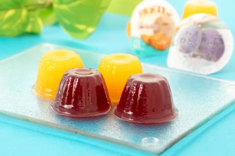 Yubari Melon and Haskap Jelly Mini set on a glass plate, featuring vibrant yellow and purple jellies, perfect for a luxurious treat or souvenir.