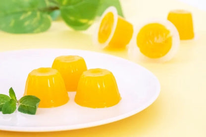 Mango flavored dietary fiber jellies on a white plate, perfect for a healthy lifestyle, providing daily fiber needs. Contains dairy.