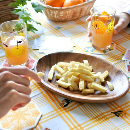 Wooden bowl of Yamato Foods Lemosco potato sticks with lemon chili flavor, served on a table with fruit drinks.