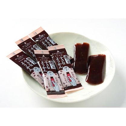 Small Yokan sweet bean paste jelly in easy push-out packs on a plate. Convenient one-hand snack, allergen-free.
