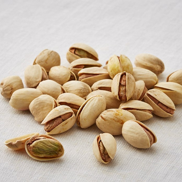High quality American pistachios seasoned with Ako salt, roasted to perfection, showcasing nutty flavor; allergen: pistachio.
