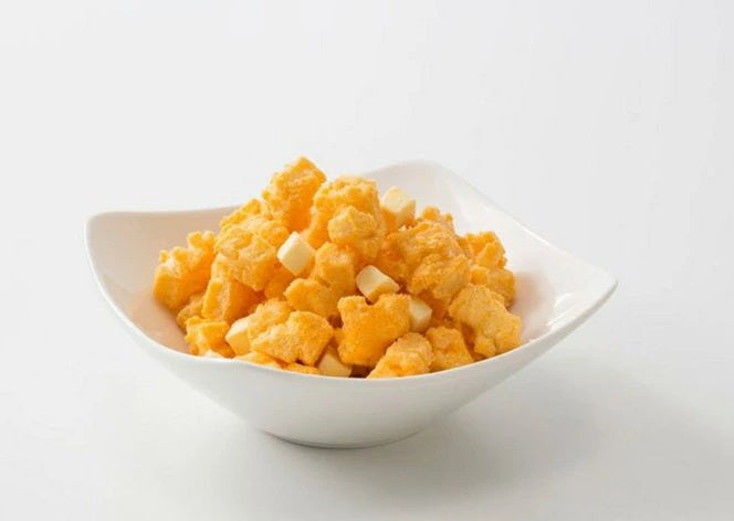 Hokkaido Cheese Okaki Rice Crackers in a white bowl, showcasing crispy texture with cheddar and gouda cheese flavors.