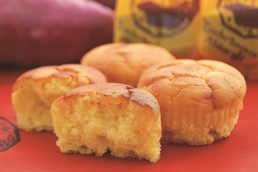 Naruto Kintoki sweet potato cake, moist and rich in flavor, made with Tokushima's finest sweet potatoes, displayed on a red background.