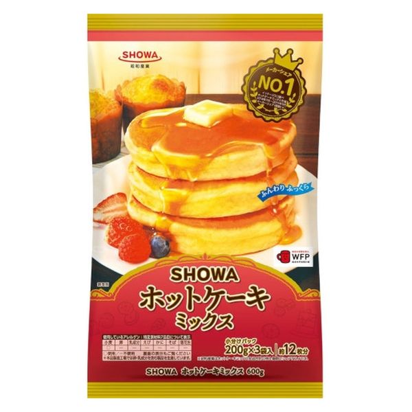SHOWA Hot Cake Mix 600g packaging with stack of fluffy pancakes, syrup, and fruits. Egg and dairy-free, wheat allergens.