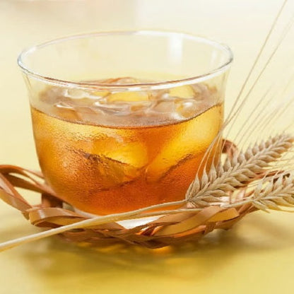 Glass of iced barley tea on a woven coaster with barley stalks, highlighting Marutsubu's Saga Prefecture origins and caffeine-free benefits.