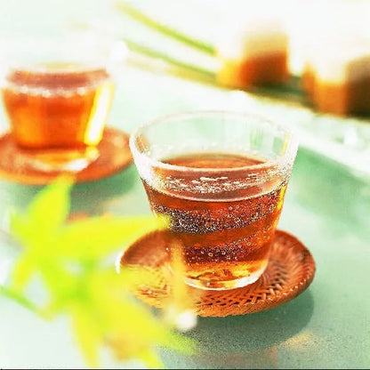 Refreshing cups of healthy barley tea for kids, caffeine-free and calorie-free, brewed from Japanese barley, on a sunny table.