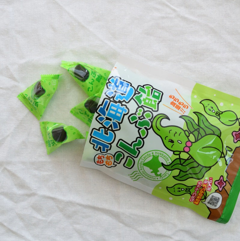 Hokkaido Kelp Chewy Candy packaging with individually wrapped candies spilling out, featuring natural kelp seaweed from Hokkaido.