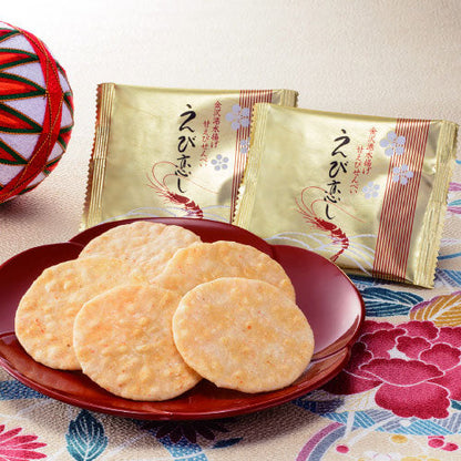 Ebi-koishi Shrimp Rice Crackers with northern pink prawn, displayed on a plate, packaged in gold, 26pcs, allergens: shrimp, wheat, soybean.