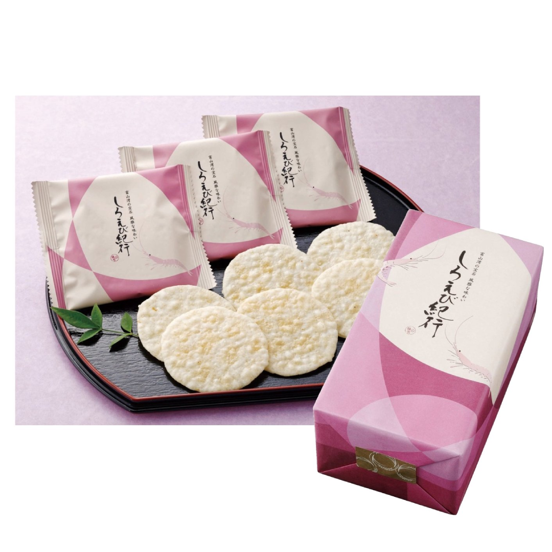 Shiroebi-kiko Shrimp Rice Cracker packs with lightly salted rice crackers made of Toyama rice and Japanese glass shrimp on a black plate.