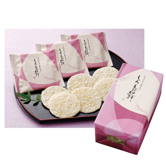 Shiroebi-kiko Shrimp Rice Cracker packs with lightly salted rice crackers made of Toyama rice and Japanese glass shrimp on a black plate.
