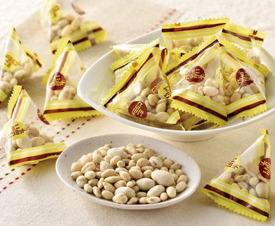 Uwasa no Tane Seeds Snack packaged and served on a dish. Contains sunflower, pumpkin, and watermelon seeds. Allergen info: Wheat, Dairy.