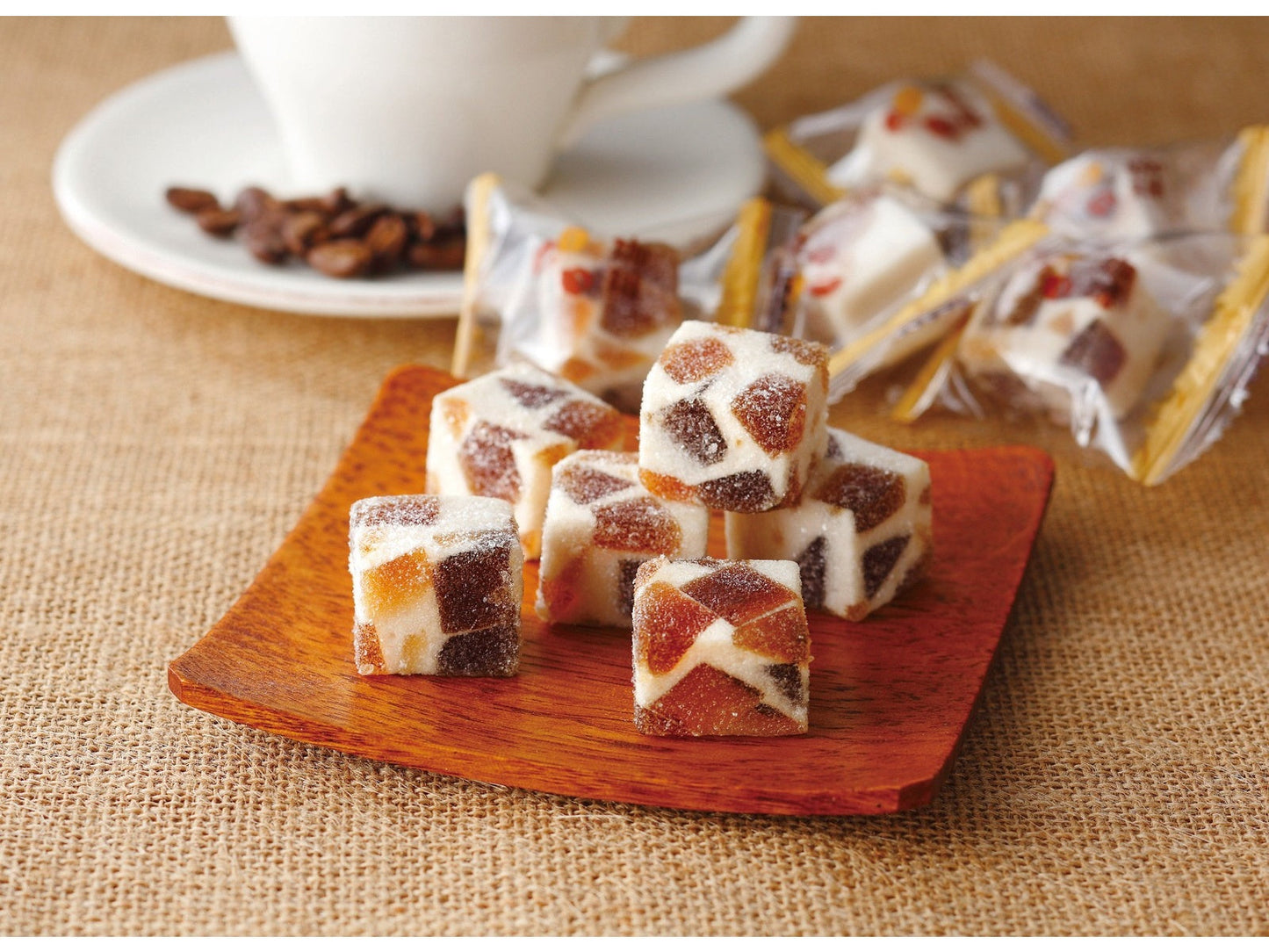 TSUYAMAYA SEIKA Coffee Fa-fa Jelly on wooden plate with coffee beans in background.