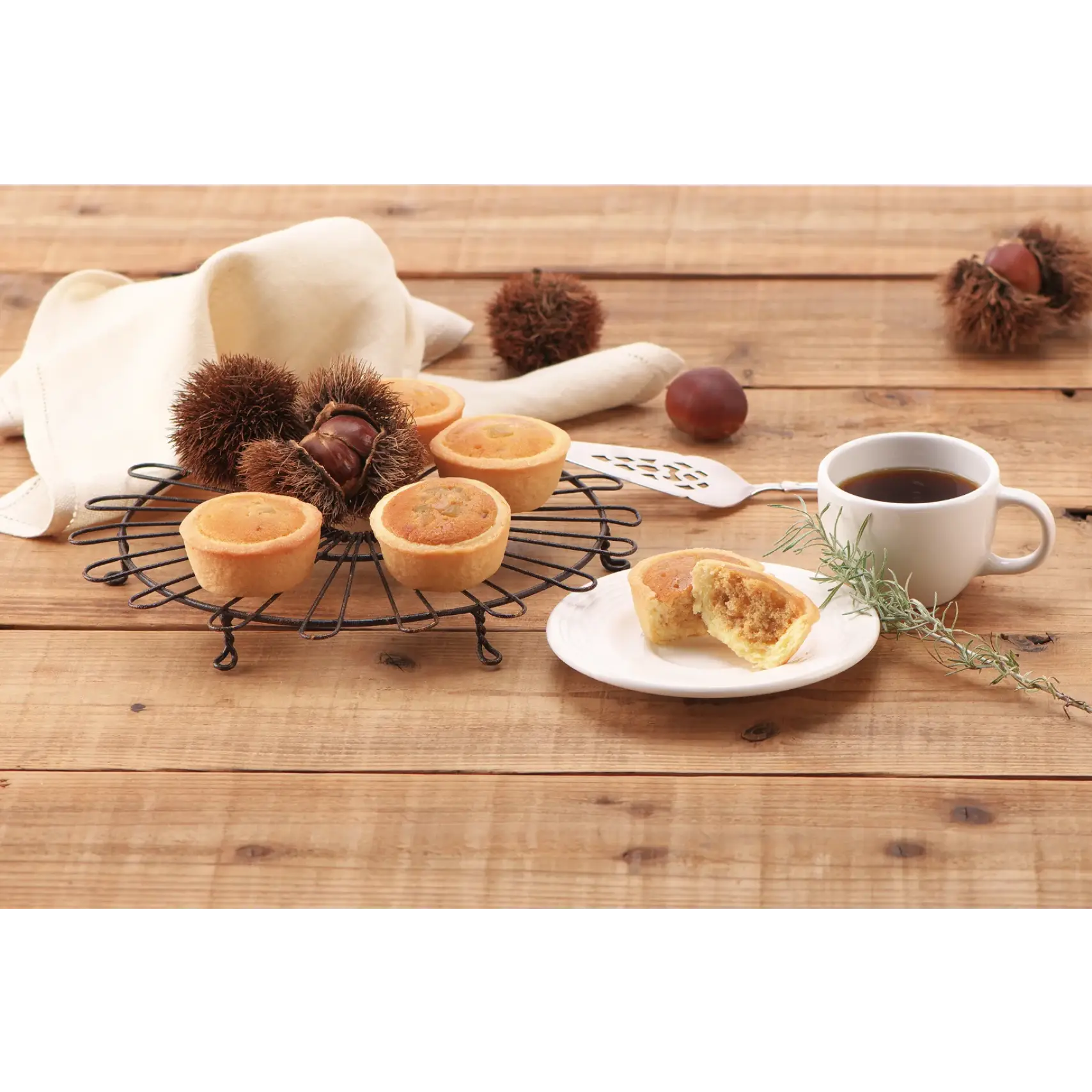 Sweet Marron Tart with chestnuts, caramel, and maple flavors on a wooden table next to a cup of coffee.