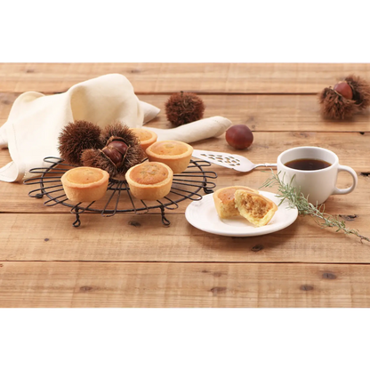 Sweet Marron Tart with chestnuts, caramel, and maple flavors on a wooden table next to a cup of coffee.