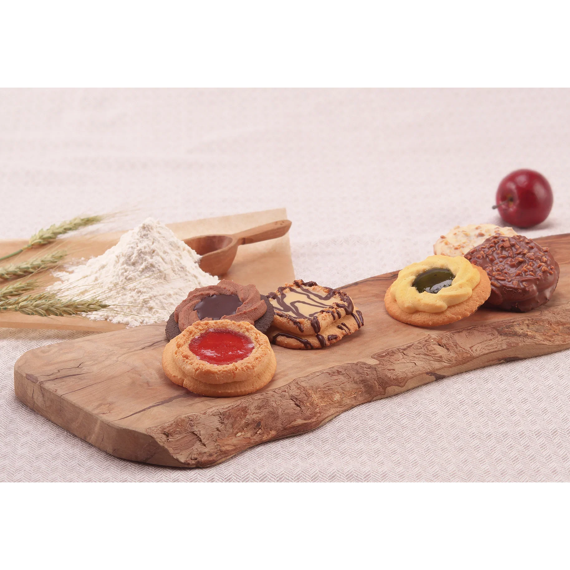 Alt Tag: Assorted baked cookies with chocolate and fruit jam decoration, on a rustic wooden board, evoking nostalgia and homemade charm.