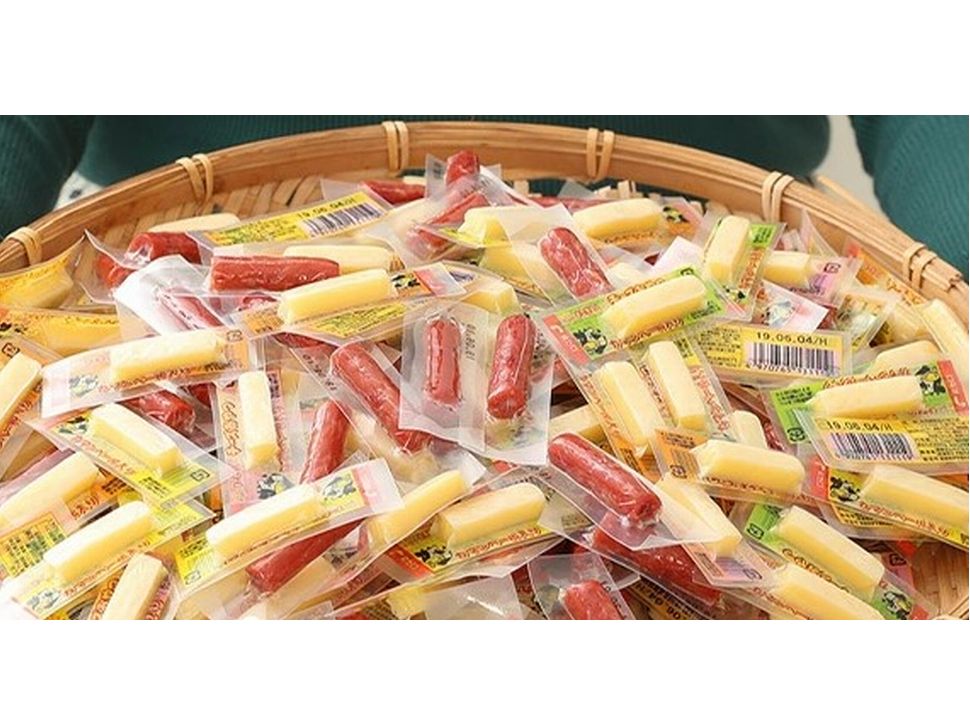 Assorted Cheese Oyatsu and Calpas snacks, featuring creamy cheese cod with camembert and spicy calpas, in a woven basket.