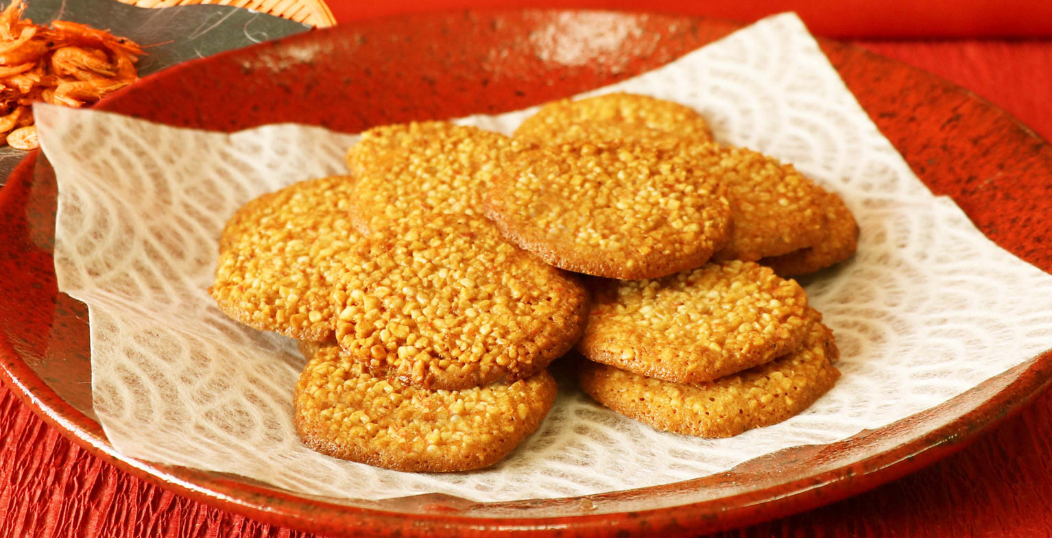 Crispy Lake Biwa Shrimp Rice Crackers from Kyoto Takara Seika on a decorative plate. Contains wheat, egg, shrimp, soy, cashew nuts.