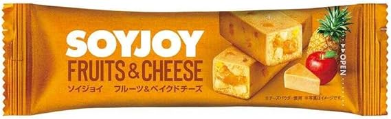 Soyjoy bar with flavors of fruits and cheese, featuring pineapple and apple. Packaging highlights texture, fig accents, and baked cheesecake taste.