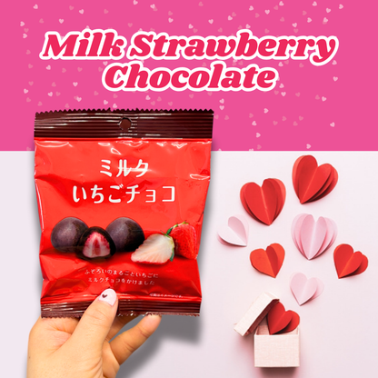 Hand holding a pack of Milk Strawberry Chocolate with pink heart decorations, perfect for Valentine's Day.