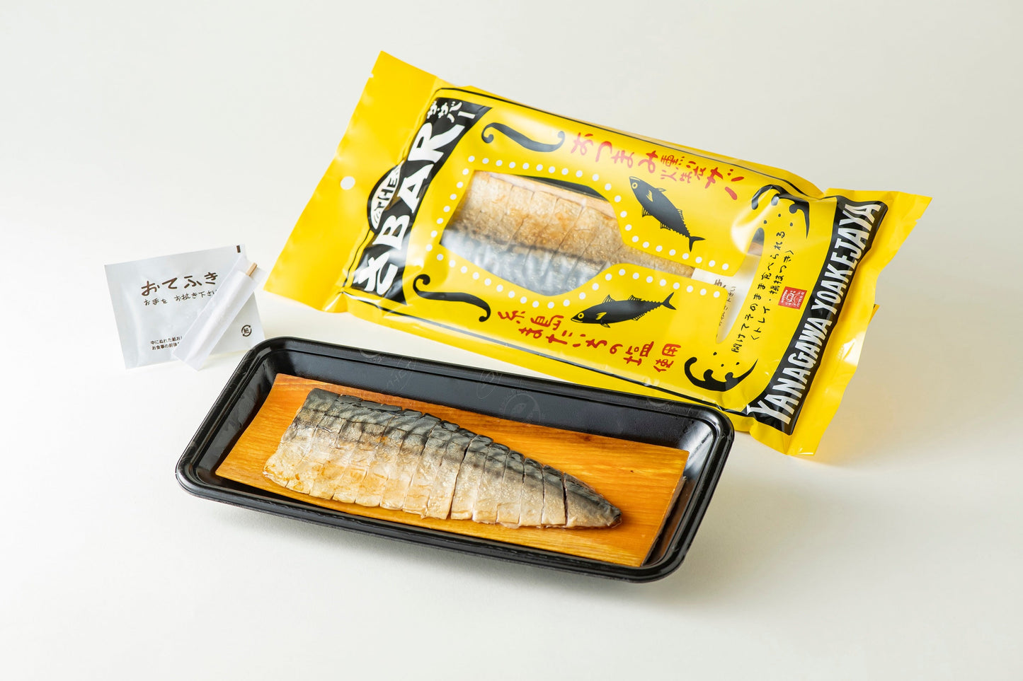 THE SABAR Smoked Mackerel with packaging, tray, toothpick, and hand towel. Ready-to-eat smoked fatty Norwegian mackerel.