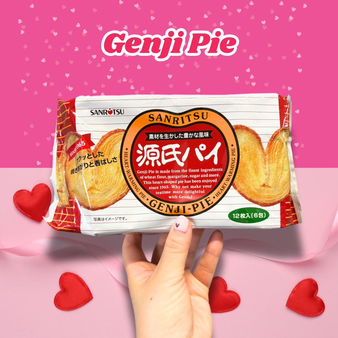 Hand holding a pack of Sanritsu Genji Pie with hearts in the background, perfect for Valentine's Day snacks.