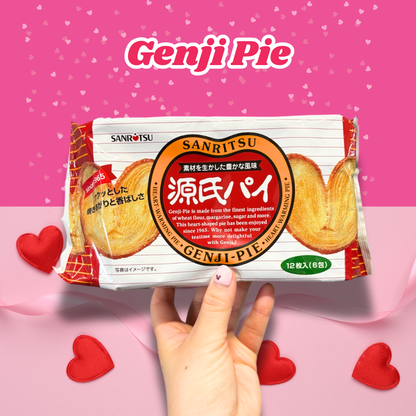 Hand holding a pack of Sanritsu Genji Pie with hearts in the background, perfect for Valentine's Day snacks.