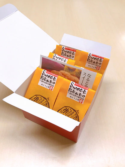 Gift box of Naruto-Kintoki sweet potato cakes from Tokushima, packaged individually in bright yellow wrappers with English and Japanese text.