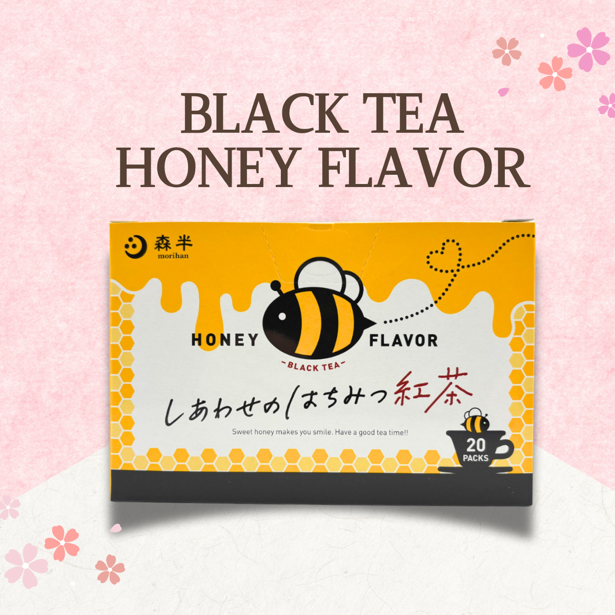 Honey-flavored black tea box with bee design against a floral pink background.
