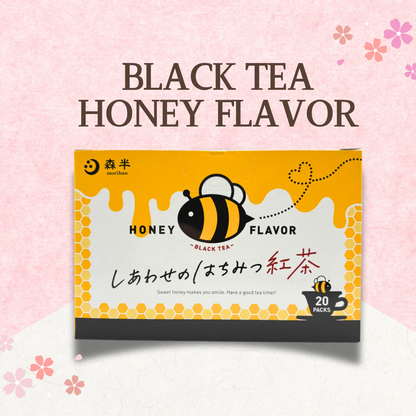 Honey-flavored black tea box with bee design against a floral pink background.